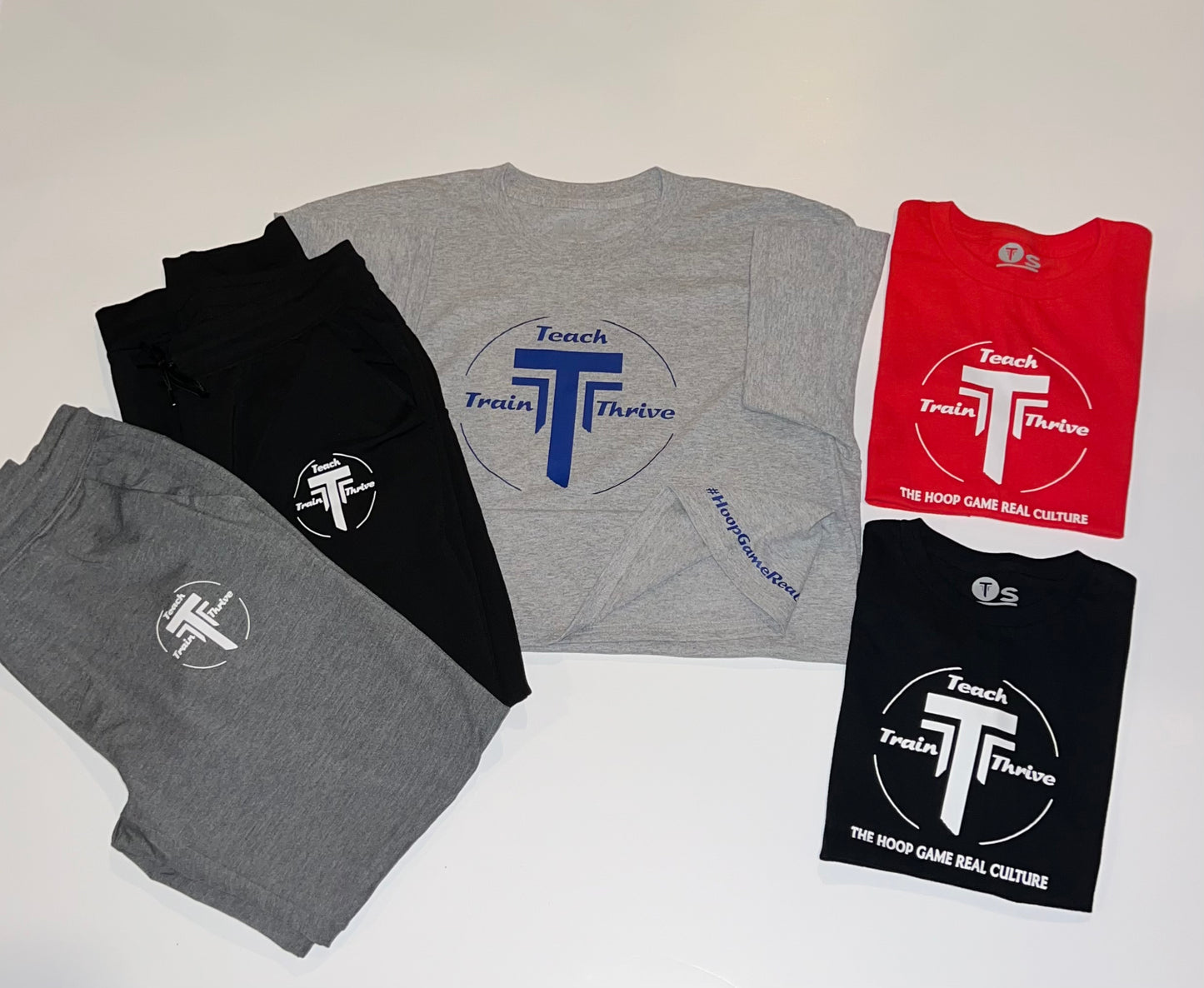 Grey T-shirts with our teach-train-thrive logo