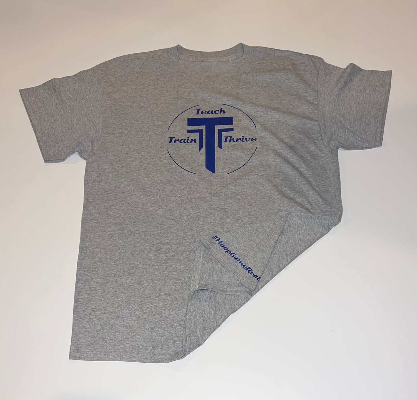 Grey T-shirts with our teach-train-thrive logo